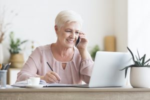 Smiling elderly lady talking to business partners
